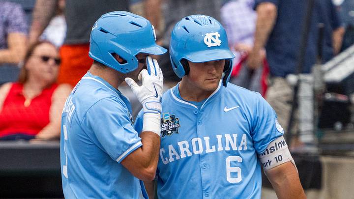 Jun 20, 2026; Omaha, NE, USA; North Carolina Tar Heels second baseman Gavin Gallaher (5) talks with designated hitter MacOn Winslow (6) after scoring on a sacrifice fly against the Oklahoma Sooners during the first inning at Charles Schwab Field. Mandatory Credit: Dylan Widger-Imagn Images