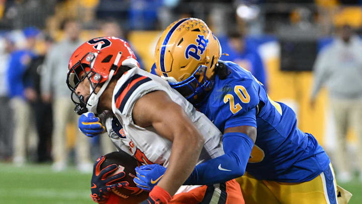 Oct 24, 2024; Pittsburgh, Pennsylvania, USA; Pittsburgh Panthers linebacker Jordan Bass (20) tackles Syracuse Orange wide receiver Emanuel Ross (18) during the second quarter at Acrisure Stadium. Mandatory Credit: Barry Reeger-Imagn Images