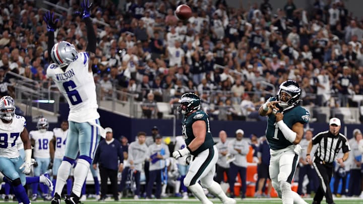 Nov 10, 2024; Arlington, Texas, USA; Philadelphia Eagles quarterback Jalen Hurts (1) throws a touchdown pass against the Dallas Cowboys in the third quarter at AT&T Stadium.