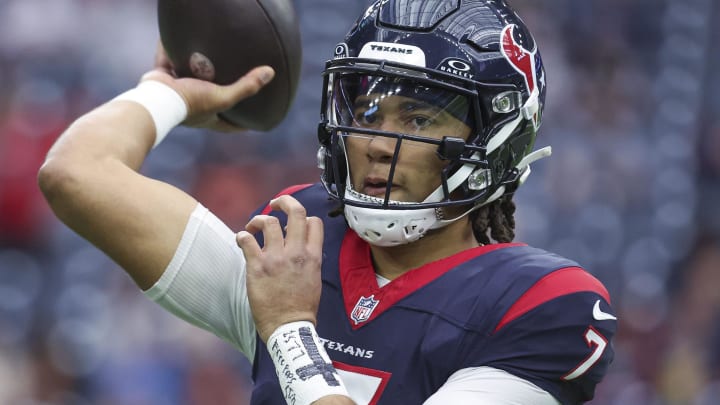 Jan 13, 2024; Houston, Texas, USA; Houston Texans quarterback C.J. Stroud (7) warms up with a message on his wrist before a 2024 AFC wild card game against the Cleveland Browns at NRG Stadium. Mandatory Credit: Troy Taormina-USA TODAY Sports