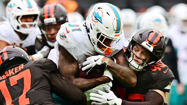 Cleveland Browns linebacker Carson Schwesinger (49) tackles Miami Dolphins running back Ollie Gordon II (31) during the second half at Huntington Bank Field last season.