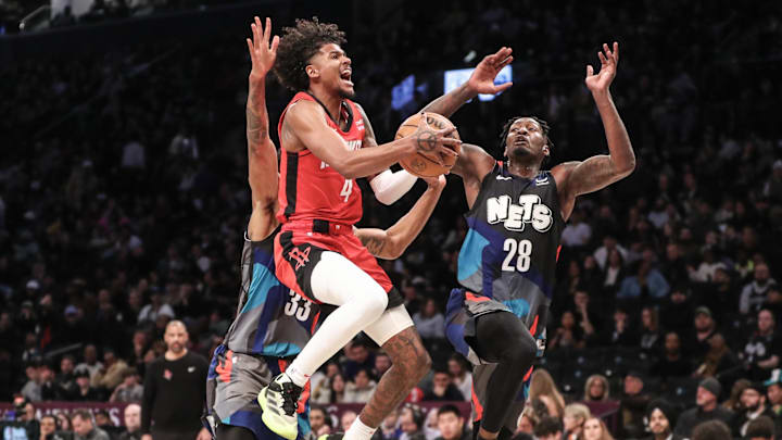 Jan 27, 2024; Brooklyn, New York, USA; Houston Rockets guard Jalen Green (4) shoots as Brooklyn Nets forward Dorian Finney-Smith (28) defends in the third quarter at Barclays Center. Mandatory Credit: Wendell Cruz-Imagn Images