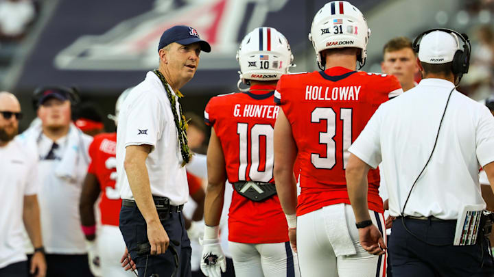 Oct 26, 2024; Tucson, Arizona, USA; Arizona Wildcats head coach Brent Brennan talks with player on the sidelines during the second quarter against the West Virginia Mountaineers at Arizona Stadium. Mandatory Credit: Aryanna Frank-Imagn Images