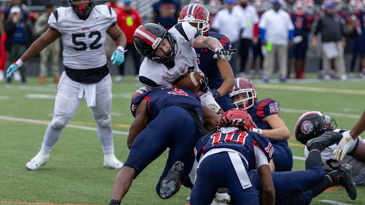 Aliquippa running back JJ Work (6) fights for extra yards while being tackled by McKeesport defensive back Kemon Spell (3) in the second half of the WPIAL Class 4A championship game between Aliquippa and McKeesport Saturday, Nov. 15, 2025 at Pine-Richland Stadium in Gibsonia, Pa.