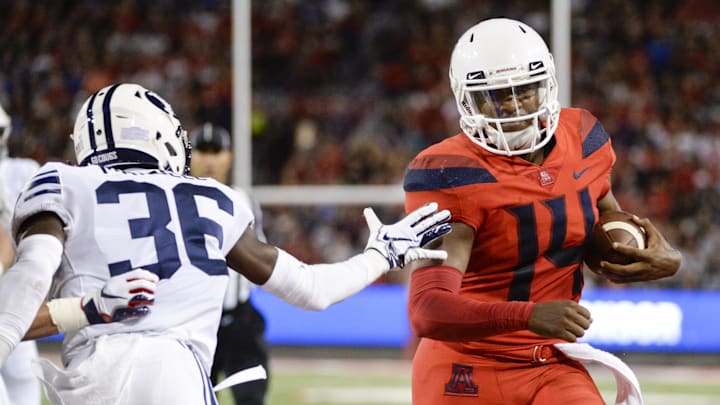 Sep 1, 2018; Tucson, AZ, USA; Arizona Wildcats quarterback Khalil Tate (14) runs the ball against Brigham Young Cougars defensive back D'Angelo Mandell (36) during the first half at Arizona Stadium. Mandatory Credit: Casey Sapio-Imagn Images