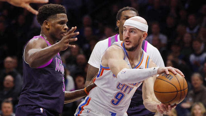 Dec 19, 2025; Minneapolis, Minnesota, USA; Oklahoma City Thunder guard Alex Caruso (9) looks to pass as Minnesota Timberwolves guard Anthony Edwards (5) defends him in the first quarter at Target Center. Mandatory Credit: Bruce Kluckhohn-Imagn Images