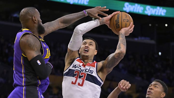 Jan 21, 2025; Los Angeles, California, USA; Los Angeles Lakers forward LeBron James (23) blocks a shot by Washington Wizards forward Kyle Kuzma (33) in the first half at Crypto.com Arena. Mandatory Credit: Jayne Kamin-Oncea-Imagn Images