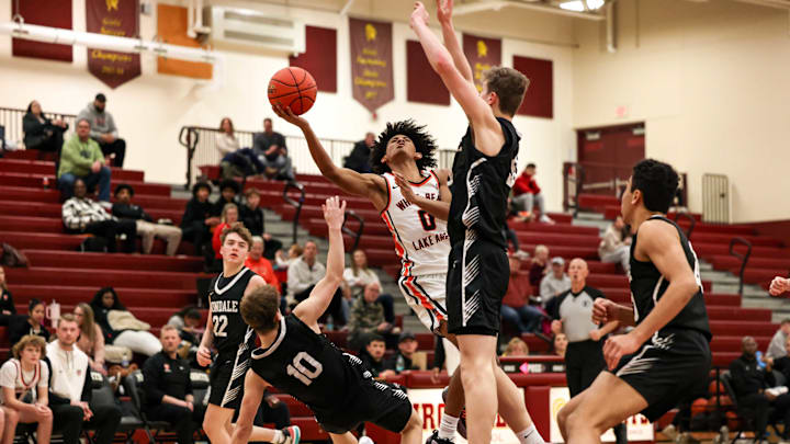 White Bear Lake's Rithy Sain meets Irondale defenders in the paint as he attempts a layup at Irondale High School on January 24