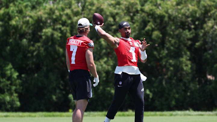 May 30, 2024; Philadelphia, PA, USA; Philadelphia Eagles quarterback Jalen Hurts (1) throws the ball in front of quarterback Kenny Pickett (7) at NovaCare Complex. Mandatory Credit: Bill Streicher-USA TODAY Sports