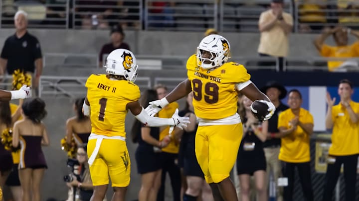 Sep 7, 2024; Tempe, Arizona, USA; Arizona State Sun Devils defensive lineman C.J. Fite (99) celebrates with defensive back Keith Abney II (1) after recovering a fumble for a touchdown against the Mississippi State Bulldogs in the first half at Mountain America Stadium. Mandatory Credit: Mark J. Rebilas-Imagn Images