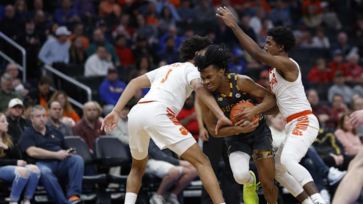Mar 13, 2024; Washington, D.C., USA; Boston College Eagles guard Donald Hand Jr. (13) drives to the basket as Clemson Tigers guard Chase Hunter (1) and Tigers guard Josh Beadle (0) defend in the first half at Capital One Arena. Mandatory Credit: Geoff Burke-Imagn Images Mar 13, 2024; Washington, D.C., USA; Boston College Eagles guard Donald Hand Jr. (13) drives to the basket as Clemson Tigers guard Chase Hunter (1) and Tigers guard Josh Beadle (0) defend in the first half at Capital One Arena. Mandatory Credit: Geoff Burke-Imagn Images