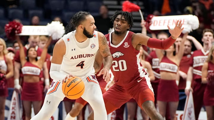 Auburn forward Johni Broome (4) is guarded by Arkansas forward Kamani Johnson (20) during the first