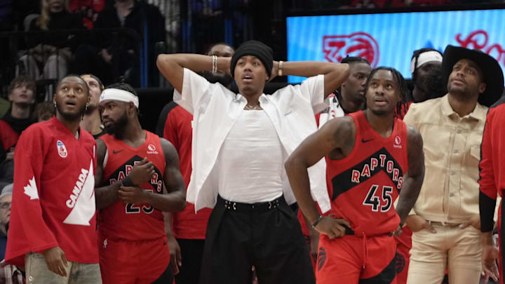 Nov 1, 2024; Toronto, Ontario, CAN; Toronto Raptors guard Immanuel Quickley, guard Jamal Shead (23) and forward Scottie Barnes  and  guard Davion Mitchell (45) and forward Bruce Brown watch a replay on the scoreboard during the second half against the Los Angeles Lakers at Scotiabank Arena. Mandatory Credit: John E. Sokolowski-Imagn Images