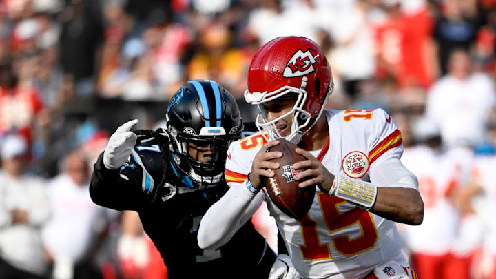 Nov 24, 2024; Charlotte, North Carolina, USA; Kansas City Chiefs quarterback Patrick Mahomes (15) is sacked by Carolina Panthers linebacker Jadeveon Clowney (7) in the second quarter at Bank of America Stadium. Mandatory Credit: Bob Donnan-Imagn Images