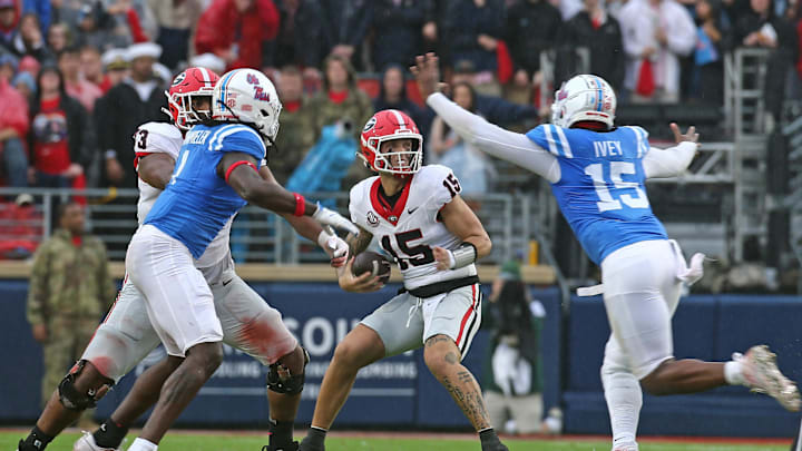 Nov 9, 2024; Oxford, Mississippi, USA; Georgia Bulldogs quarterback Carson Beck (15) drops back to pass as Mississippi Rebels defensive Jared Ivey (15) rushes during the first half at Vaught-Hemingway Stadium. Mandatory Credit: Petre Thomas-Imagn Images Nov 9, 2024; Oxford, Mississippi, USA; Georgia Bulldogs quarterback Carson Beck (15) drops back to pass as Mississippi Rebels defensive Jared Ivey (15) rushes during the first half at Vaught-Hemingway Stadium. Mandatory Credit: Petre Thomas-Imagn Images