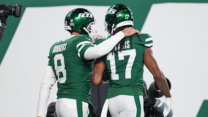 Jan 5, 2025; East Rutherford, New Jersey, USA; New York Jets quarterback Aaron Rodgers (8) and wide receiver Davante Adams (17) celebrate after a touchdown during the second half against the Miami Dolphins at MetLife Stadium. Mandatory Credit: Vincent Carchietta-Imagn Images