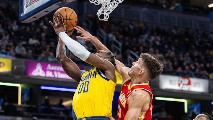 Jan 5, 2024; Indianapolis, Indiana, USA; Indiana Pacers guard Bennedict Mathurin (00) attempts to shoot the ball while Atlanta Hawks guard Bogdan Bogdanovic (13) defends in the first half at Gainbridge Fieldhouse. Mandatory Credit: Trevor Ruszkowski-Imagn Images Jan 5, 2024; Indianapolis, Indiana, USA; Indiana Pacers guard Bennedict Mathurin (00) attempts to shoot the ball while Atlanta Hawks guard Bogdan Bogdanovic (13) defends in the first half at Gainbridge Fieldhouse. Mandatory Credit: Trevor Ruszkowski-Imagn Images