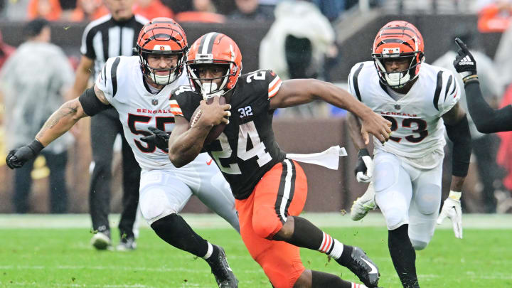 Sep 10, 2023; Cleveland, Ohio, USA; Cleveland Browns running back Nick Chubb (24) runs with the ball as Cincinnati Bengals linebacker Logan Wilson (55) and safety Dax Hill (23) defend during the first half at Cleveland Browns Stadium. Mandatory Credit: Ken Blaze-USA TODAY Sports