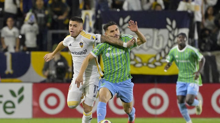 Nov 30, 2024; Carson, California, USA; LA Galaxy forward Gabriel Pec (11) and Seattle Sounders FC midfielder Cristian Roldan (7) battle for the ball in the second half in the 2024 MLS Cup Western Conference Final match at Dignity Health Sports Park. Mandatory Credit: Jayne Kamin-Oncea-Imagn Images