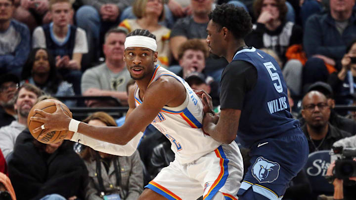 Mar 5, 2025; Memphis, Tennessee, USA; Oklahoma City Thunder guard Shai Gilgeous-Alexander (2) handles the ball as Memphis Grizzlies guard Vince Williams Jr. (5) defends during the fourth quarter at FedExForum. Mandatory Credit: Petre Thomas-Imagn Images