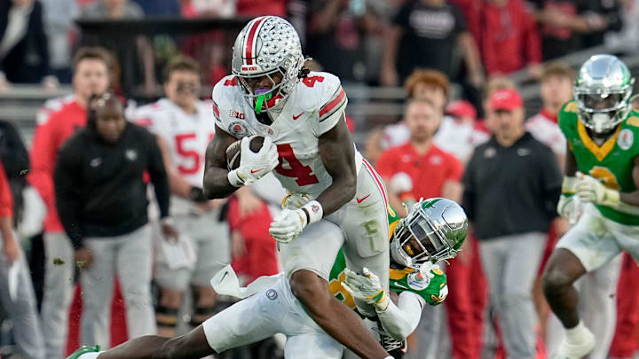 Ohio State Buckeyes wide receiver Jeremiah Smith (4) runs past Oregon Ducks defensive back Dontae Manning (8) during the College Football Playoff quarterfinal at the Rose Bowl in Pasadena, Calif. on Jan. 1, 2025. Ohio State won 41-21.
