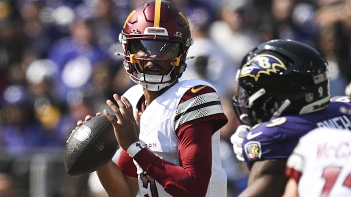 Oct 13, 2024; Baltimore, Maryland, USA;  Washington Commanders quarterback Jayden Daniels (5) loos to throws during the first quarter against the Baltimore Ravens at M&T Bank Stadium. Mandatory Credit: Tommy Gilligan-Imagn Images
