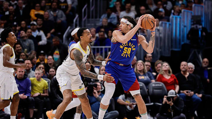 Mar 9, 2024; Denver, Colorado, USA; Denver Nuggets forward Aaron Gordon (50) controls the ball as Utah Jazz forward John Collins (20) guards in the first quarter at Ball Arena. Mandatory Credit: Isaiah J. Downing-Imagn Images