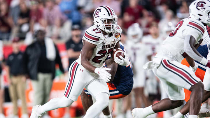 Dec 31, 2024; Orlando, FL, USA; South Carolina Gamecocks running back Oscar Adaway III (27) runs the ball against the Illinois Fighting Illini in the. fourth quarter at Camping World Stadium. Mandatory Credit: Jeremy Reper-Imagn Images