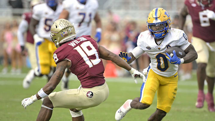 Oct 11, 2025; Tallahassee, Florida, USA; Pittsburgh Panthers running back Desmond Reid (0) runs the ball past Florida State Seminoles defensive back Jerry Wilson (19) during the second half at Doak S. Campbell Stadium. Mandatory Credit: Melina Myers-Imagn Images