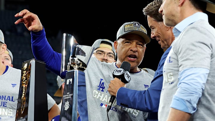 Oct 20, 2024; Los Angeles, California, USA; Los Angeles Dodgers manager Dave Roberts (30) is interviewed with NLCS Trophy after the Los Angeles Dodgers beat the New York Mets during in six of the NLCS for the 2024 MLB playoffs at Dodger Stadium. 