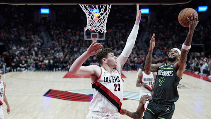 Nov 13, 2024; Portland, Oregon, USA; Minnesota Timberwolves shooting guard Nickeil Alexander-Walker (9) shoots the ball against Portland Trail Blazers center Donovan Clingan (23) during the first half at Moda Center. Mandatory Credit: Soobum Im-Imagn Images