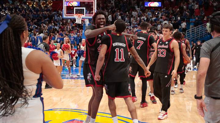 Louisville Cardinals forward Flory Bidunga (40) celebrates with Louisville Cardinals guard De'Shayne Montgomery (11) after defeating Kansas Jayhawks 89-83 in the exhibition game inside Allen Fieldhouse in Lawrence, Kansas on Oct. 21, 2026. Louisville Cardinals forward Flory Bidunga (40) celebrates with Louisville Cardinals guard De'Shayne Montgomery (11) after defeating Kansas Jayhawks 89-83 in the exhibition game inside Allen Fieldhouse in Lawrence, Kansas on Oct. 21, 2026.