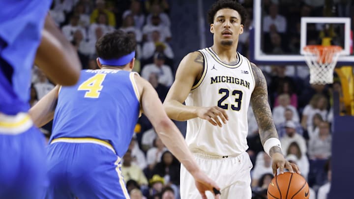 Feb 14, 2026; Ann Arbor, Michigan, USA; Michigan Wolverines forward Yaxel Lendeborg (23) is defended by UCLA Bruins guard Jamar Brown (4) in the first half at Crisler Center. Mandatory Credit: Rick Osentoski-Imagn Images
