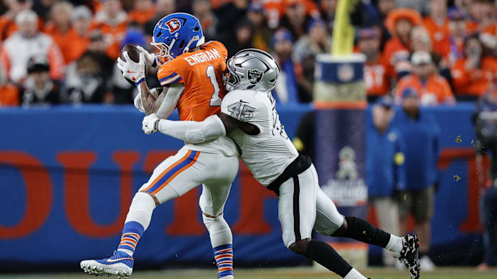 Nov 6, 2025; Denver, Colorado, USA; Denver Broncos tight end Evan Engram (1) makes a catch over Las Vegas Raiders linebacker Devin White (45) during the first half at Empower Field at Mile High. Mandatory Credit: Isaiah J. Downing-Imagn Images