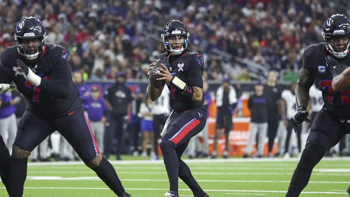 Dec 25, 2024; Houston, Texas, USA; Houston Texans quarterback C.J. Stroud (7) looks for an open receiver during the game against the Baltimore Ravens at NRG Stadium. Mandatory Credit: Troy Taormina-Imagn Images