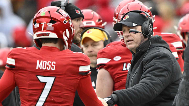 Nov 29, 2025; Louisville, Kentucky, USA;  Louisville Cardinals head coach Jeff Brohm celebrates with Louisville Cardinals quarterback Miller Moss (7) during the second half against the Kentucky Wildcats at L&N Federal Credit Union Stadium. Louisville defeated Kentucky 41-0. Mandatory Credit: Jamie Rhodes-Imagn Images