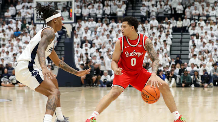 Jan 30, 2025; University Park, Pennsylvania, USA; Ohio State Buckeyes guard John Mobley Jr (0) dribbles the ball as Penn State Nittany Lions guard Nick Kern Jr (3) defends during the first half at Rec Hall. Mandatory Credit: Matthew O'Haren-Imagn Images