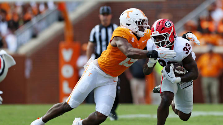 Sep 13, 2025; Knoxville, Tennessee, USA; Tennessee Volunteers defensive lineman Joshua Josephs (19) tackles Georgia Bulldogs running back Chauncey Bowens (33) during the second half at Neyland Stadium. Mandatory Credit: Alan Poizner-Imagn Images