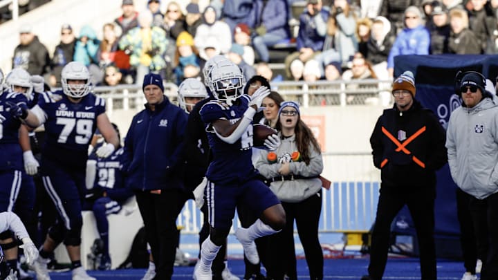 Dec 23, 2023; Boise, ID, USA; Utah State Aggies running back Davon Booth (6) runs for gain during