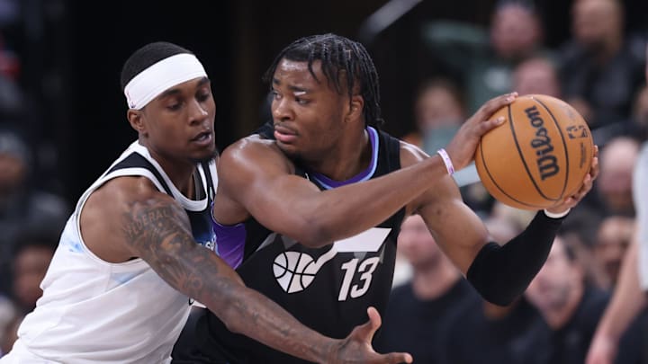 Feb 28, 2025; Salt Lake City, Utah, USA; Utah Jazz guard Isaiah Collier (13) holds the ball away from Minnesota Timberwolves forward Jaden McDaniels during the second half at Delta Center. Mandatory Credit: Rob Gray-Imagn Images