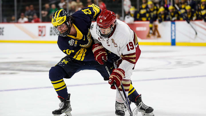 Michigan defenseman Seamus Casey and Boston College forward Cutter Gauthier battle for position during the third period of the Frozen Four semifinal game at Xcel Energy Center.