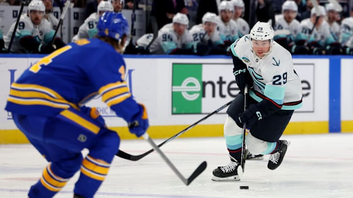 Jan 11, 2025; Buffalo, New York, USA;  Seattle Kraken defenseman Vince Dunn (29) carriers the puck up ice during the third period against the Buffalo Sabres at KeyBank Center. Mandatory Credit: Timothy T. Ludwig-Imagn Images