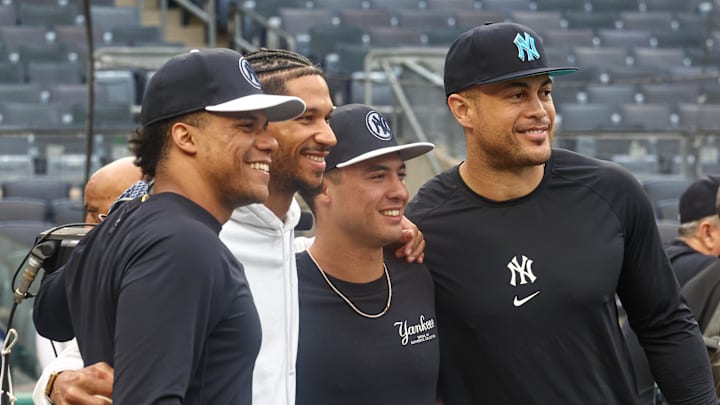 Sep 24, 2024; Bronx, New York, USA;  New York Knick guard Josh Hart, center-left, poses for a photo with New York Yankees right fielder Juan Soto (22) and shortstop Anthony Volpe (11) and designated hitter Giancarlo Stanton (27) before the game against the Baltimore Orioles at Yankee Stadium. Mandatory Credit: Vincent Carchietta-Imagn Images