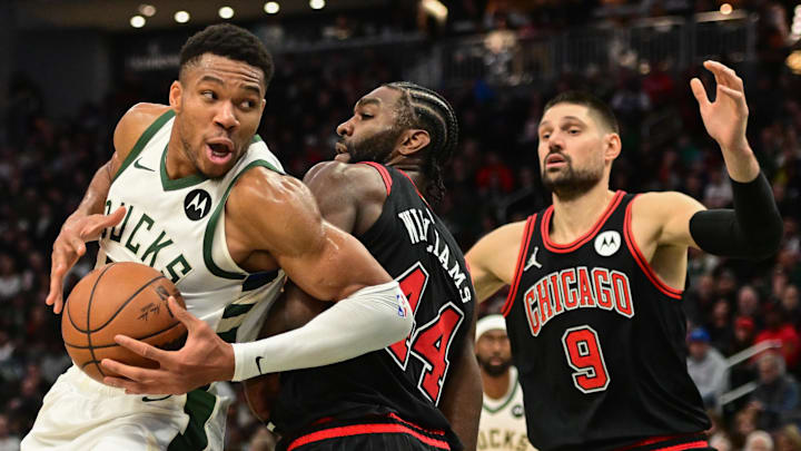 Nov 13, 2023; Milwaukee, Wisconsin, USA; Milwaukee Bucks forward Giannis Antetokounmpo (34) drives around Chicago Bulls forward Patrick Williams (44) and center Nikola Vucevic (9) in the fourth quarter at Fiserv Forum. Mandatory Credit: Benny Sieu-Imagn Images