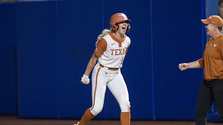 Jun 4, 2025; Oklahoma City, OK, USA; Texas Longhorns utility Reese Atwood (14) yells after hitting an intentional walk pitch for a single and driving in two runs in the sixth inning against the Texas Tech Red Raiders during game one of the NCAA Softball Women's College World Series finals at Devon Park. Mandatory Credit: Brett Rojo-Imagn Images Jun 4, 2025; Oklahoma City, OK, USA; Texas Longhorns utility Reese Atwood (14) yells after hitting an intentional walk pitch for a single and driving in two runs in the sixth inning against the Texas Tech Red Raiders during game one of the NCAA Softball Women's College World Series finals at Devon Park. Mandatory Credit: Brett Rojo-Imagn Images