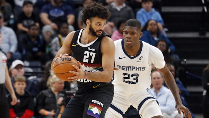 Nov 24, 2025; Memphis, Tennessee, USA; Denver Nuggets guard Jamal Murray (27) handles the ball as Memphis Grizzlies forward Cedric Coward (23) defends during the fourth quarter at FedExForum. Mandatory Credit: Petre Thomas-Imagn Images