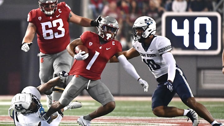 Sep 4, 2021; Pullman, Washington, USA; Washington State Cougars wide receiver Travel Harris (1) is tracked by Utah State Aggies linebacker Cash Gilliam, left and Utah State Aggies linebacker AJ Vongphachanh in the first half at Gesa Field at Martin Stadium. Mandatory Credit: James Snook-Imagn Images Sep 4, 2021; Pullman, Washington, USA; Washington State Cougars wide receiver Travel Harris (1) is tracked by Utah State Aggies linebacker Cash Gilliam, left and Utah State Aggies linebacker AJ Vongphachanh in the first half at Gesa Field at Martin Stadium. Mandatory Credit: James Snook-Imagn Images
