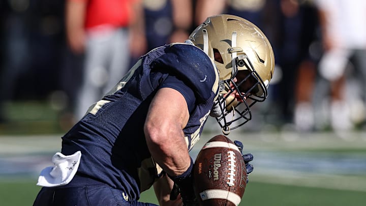 Oct 26, 2024; East Rutherford, New Jersey, USA; Navy Midshipmen running back Eli Heidenreich (22) can not secure a punt during the second half against the Notre Dame Fighting Irish at MetLife Stadium. Mandatory Credit: Vincent Carchietta-Imagn Images