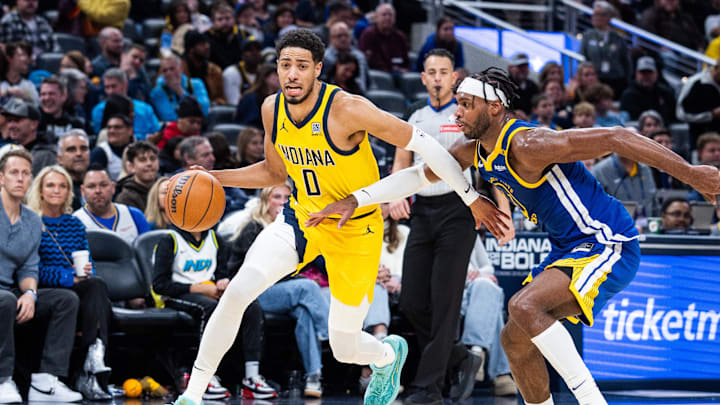Jan 10, 2025; Indianapolis, Indiana, USA; Indiana Pacers guard Tyrese Haliburton (0) dribbles the ball while Golden State Warriors guard Buddy Hield (7) defends in the second half at Gainbridge Fieldhouse. Mandatory Credit: Trevor Ruszkowski-Imagn Images Jan 10, 2025; Indianapolis, Indiana, USA; Indiana Pacers guard Tyrese Haliburton (0) dribbles the ball while Golden State Warriors guard Buddy Hield (7) defends in the second half at Gainbridge Fieldhouse. Mandatory Credit: Trevor Ruszkowski-Imagn Images