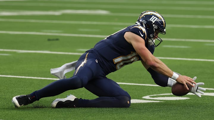 Dec 27, 2025; Inglewood, California, USA;  Los Angeles Chargers quarterback Justin Herbert (10) recovers his fumble against the Houston Texans during the first half at SoFi Stadium. Mandatory Credit: Kiyoshi Mio-Imagn Images